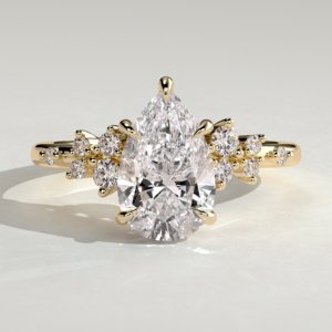 Pear Solitaire with Clustered Stones Engagement Ring